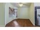 Dining area featuring hard wood floors and a stainless steel refrigerator at 909 E Harwell Rd, Phoenix, AZ 85042