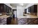 Modern kitchen boasting stainless steel appliances, granite countertops, and dark wood cabinets at 909 E Harwell Rd, Phoenix, AZ 85042