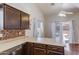 Contemporary kitchen featuring wooden cabinetry, a breakfast bar, and abundant natural light from the windows at 909 E Harwell Rd, Phoenix, AZ 85042
