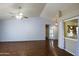 Inviting living room with a ceiling fan, wood floors, and soft natural light illuminating the space at 909 E Harwell Rd, Phoenix, AZ 85042