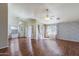 Expansive living room with wood floors, a ceiling fan, and bright natural light from large windows at 909 E Harwell Rd, Phoenix, AZ 85042