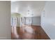 Open living space featuring wood floors, a ceiling fan, and large windows for ample natural light at 909 E Harwell Rd, Phoenix, AZ 85042