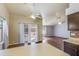 Open living space with wood floors, ceiling fan, and sliding glass doors to the outdoor space at 909 E Harwell Rd, Phoenix, AZ 85042