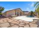 Beautiful backyard with a pool, spa, stone pavers, and a covered patio, perfect for entertaining at 10214 E Moonshadow Way, Gold Canyon, AZ 85118