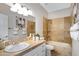 Bathroom featuring tiled tub, sink and countertop, and towel racks at 10214 E Moonshadow Way, Gold Canyon, AZ 85118