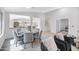 Sunlit dining area with seating for six, flowing seamlessly into the living room and kitchen at 10214 E Moonshadow Way, Gold Canyon, AZ 85118