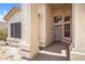 Welcoming entryway featuring a covered porch, gray front door and a sidelight for sunlit interiors at 10214 E Moonshadow Way, Gold Canyon, AZ 85118