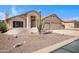 Inviting single-story home with a well-maintained desert landscape, adding character to the property at 10214 E Moonshadow Way, Gold Canyon, AZ 85118