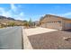 Appealing single-story home with desert landscaping, set against a backdrop of beautiful mountain views at 10214 E Moonshadow Way, Gold Canyon, AZ 85118