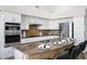 A well-lit kitchen showcases stainless steel appliances and a granite island with a sink at 10214 E Moonshadow Way, Gold Canyon, AZ 85118