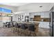 Bright kitchen featuring a granite island with seating, stainless steel appliances, and white cabinets at 10214 E Moonshadow Way, Gold Canyon, AZ 85118