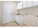 Laundry room features white cabinets and tiled floor at 10214 E Moonshadow Way, Gold Canyon, AZ 85118