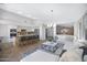 Open-concept living space with a kitchen island, white sofa, and modern lighting at 10214 E Moonshadow Way, Gold Canyon, AZ 85118