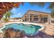 Backyard features a pool, palm trees, and ample space at 10214 E Moonshadow Way, Gold Canyon, AZ 85118