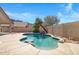 Inviting pool with rock waterfall feature and swim-up bar, surrounded by desert landscaping at 10214 E Moonshadow Way, Gold Canyon, AZ 85118