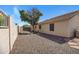 Side yard featuring gravel landscaping with a mature tree and access to the backyard at 10214 E Moonshadow Way, Gold Canyon, AZ 85118