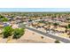 Aerial view of a desert neighborhood with well-maintained homes and landscaping in a planned community at 10521 W Donald Dr, Peoria, AZ 85383