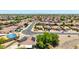 Wide aerial view of a desert neighborhood, showing mature landscaping on the street and residential solar at 10521 W Donald Dr, Peoria, AZ 85383