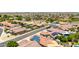 Aerial view of a neighborhood showcasing homes with solar panels and well-maintained landscaping at 10521 W Donald Dr, Peoria, AZ 85383