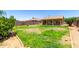 Overhead view of a large backyard, with green grass, desert landscaping, and a covered patio at 10521 W Donald Dr, Peoria, AZ 85383