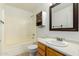 Well-lit bathroom featuring a shower-tub combo, vanity with sink, and ample storage at 10521 W Donald Dr, Peoria, AZ 85383