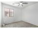 Bright bedroom with neutral paint, carpet, a window, and a ceiling fan at 10521 W Donald Dr, Peoria, AZ 85383
