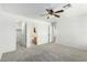 Spacious bedroom with plush carpeting, ceiling fan, walk-in closet and en-suite bathroom at 10521 W Donald Dr, Peoria, AZ 85383