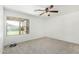 Bedroom featuring neutral carpet, a ceiling fan, and a window providing natural light at 10521 W Donald Dr, Peoria, AZ 85383