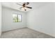 Well-lit bedroom with a window, neutral carpet, and minimalist design at 10521 W Donald Dr, Peoria, AZ 85383