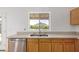 Bright kitchen with light cabinets, stainless steel sink, and a large window overlooking the backyard at 10521 W Donald Dr, Peoria, AZ 85383