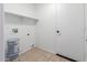 Laundry room with tile floor, storage shelves, washer hookups and a utility door at 10521 W Donald Dr, Peoria, AZ 85383
