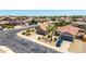 Inviting front yard with mature trees, two-car garage, and desert landscaping contributes to this home's curb appeal at 10521 W Donald Dr, Peoria, AZ 85383