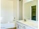Bathroom with soaking tub, dual vanity, and spacious walk-in closet at 10722 W Quartz Dr, Casa Grande, AZ 85193