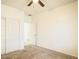 This bedroom has neutral carpet and a ceiling fan with access to an adjoining room at 10722 W Quartz Dr, Casa Grande, AZ 85193