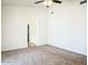 Cozy bedroom with neutral carpet, ceiling fan, and adjoining bath at 10722 W Quartz Dr, Casa Grande, AZ 85193