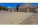 Charming one-story house with a long driveway and a two-car garage at 10722 W Quartz Dr, Casa Grande, AZ 85193