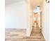 Hallway featuring wood-look flooring with a view to the living room at 10722 W Quartz Dr, Casa Grande, AZ 85193