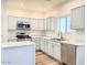 Well-lit kitchen with white cabinetry, quartz counters, and modern appliances at 10722 W Quartz Dr, Casa Grande, AZ 85193