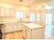 Modern kitchen features white cabinets, island, and stainless steel appliances at 10722 W Quartz Dr, Casa Grande, AZ 85193