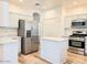 Modern kitchen boasts stainless steel appliances and a bright kitchen island at 10722 W Quartz Dr, Casa Grande, AZ 85193