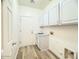 Functional laundry room with white cabinets and sink at 10722 W Quartz Dr, Casa Grande, AZ 85193