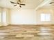 Bright living room featuring wood flooring and large windows at 10722 W Quartz Dr, Casa Grande, AZ 85193