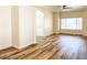 Bright and airy living room boasting wood-look floors and natural light at 10722 W Quartz Dr, Casa Grande, AZ 85193