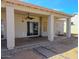 A covered patio has a ceiling fan and overlooks the yard at 10722 W Quartz Dr, Casa Grande, AZ 85193