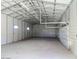 Interior view of a large, empty metal shed with high ceilings and ample storage space at 10722 W Quartz Dr, Casa Grande, AZ 85193