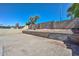 This backyard is surrounded by block walls and offers tiered garden beds at 11224 W Puget Ave, Peoria, AZ 85345