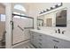 Bathroom with double sink vanity, modern fixtures, walk-in shower, and large rectangular mirror at 11224 W Puget Ave, Peoria, AZ 85345