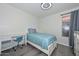 This bedroom offers a well lit space with a desk, a bed, and neutral colored walls at 11224 W Puget Ave, Peoria, AZ 85345
