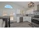 Bright kitchen features modern stainless steel appliances, gray backsplash, and updated lighting at 11224 W Puget Ave, Peoria, AZ 85345