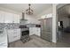 Kitchen boasts stainless steel appliances, modern backsplash, and quartz countertops at 11224 W Puget Ave, Peoria, AZ 85345